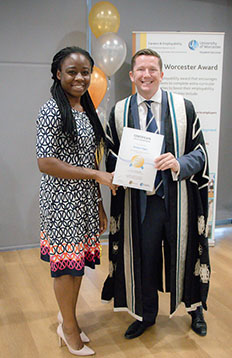 A student is receiving her Worcester award Certificate from Ross Renton